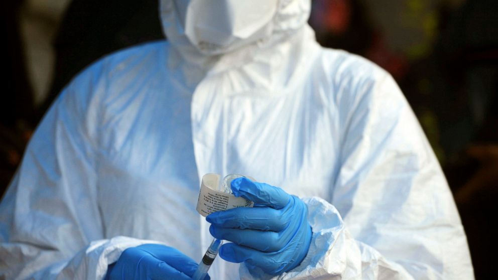 FILE - In this file photo dated Wednesday, Aug 8, 2018, a healthcare worker from the World Health Organization prepares to give an Ebola vaccination in Mangina, Democratic Republic of Congo. Armed assailants attacked an Ebola treatment center in Bute