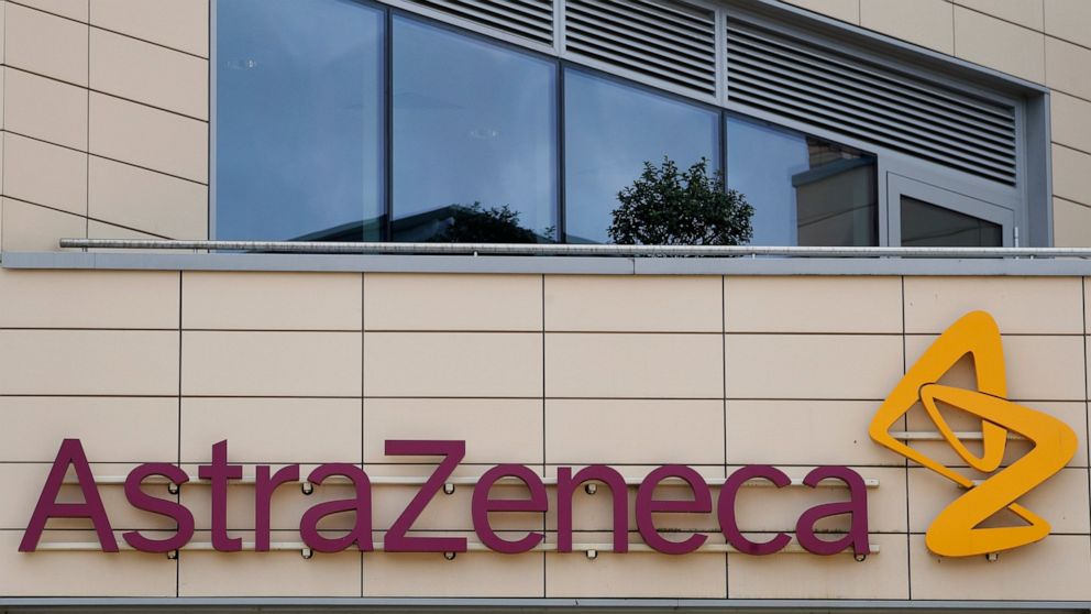 FILE - In this Saturday, July 18, 2020 file photo a general view of AstraZeneca offices and the corporate logo in Cambridge, England. Scientists at Oxford University say their experimental coronavirus vaccine has been shown in an early trial to promp