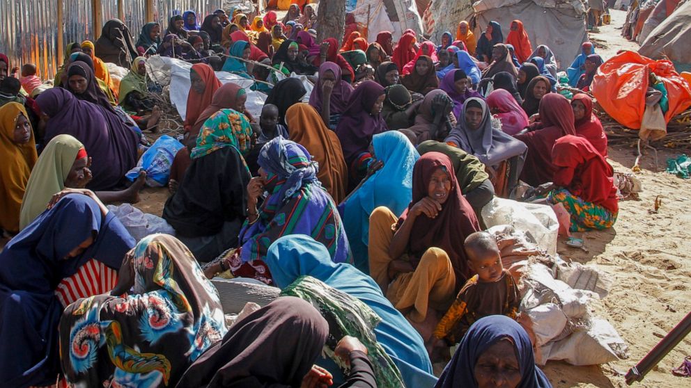 FILE - Somalis who fled drought-stricken areas sit at a makeshift camp on the outskirts of the capital Mogadishu, Somalia on Feb. 4, 2022. Two U.N. food agencies issued stark warnings on Monday, June 6, 2022 about multiple, looming food crises on the
