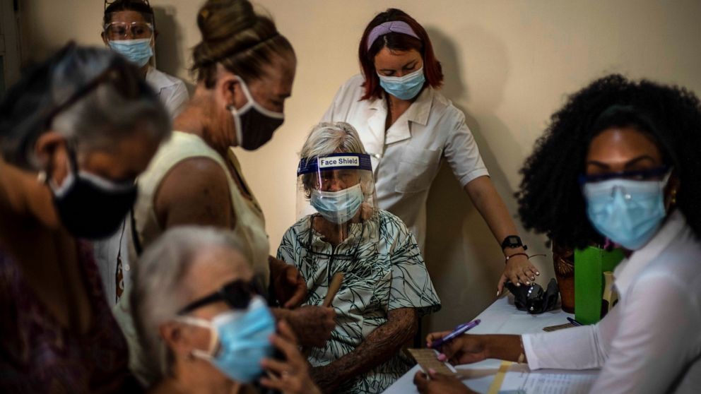 FILE - In this June 23, 2021 file photo, people sign up for a dose of the Cuban Abdala COVID-19 vaccine in Havana, Cuba. Cuba has been trying to rapidly roll out the two vaccines that it has approved for massive use, Abdala and Soberana, both of whic