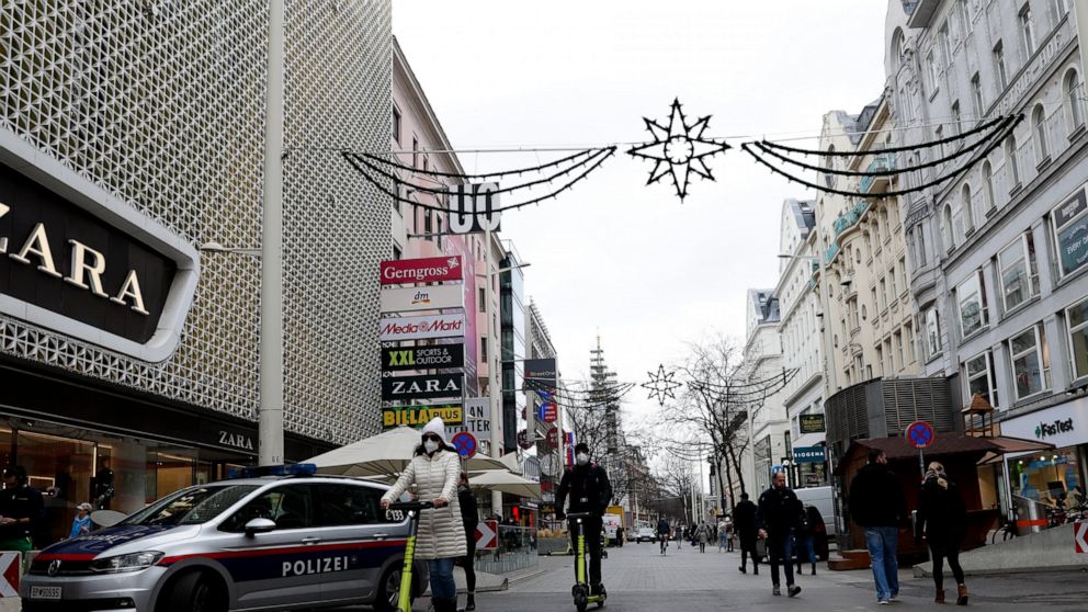 A police car stand on the shopping street Marienhilfer Strasse in Vienna, Austria, Friday, Nov. 19, 2021. Austrian Chancellor Alexander Schallenberg says the country will go into a national lockdown to contain a fourth wave of coronavirus cases. Scha