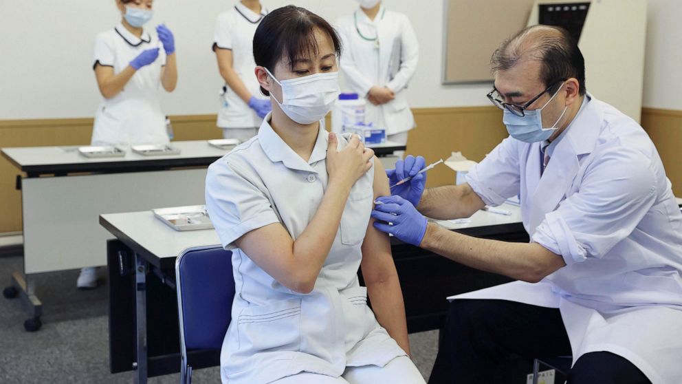 A medical worker of Tokyo Medical Center receives a booster shot of the Pfizer COVID-19 vaccine Wednesday, Dec. 1, 2021 in Tokyo. Japan has started administering the booster shots to health care workers on Wednesday. (Kyodo News via AP)
