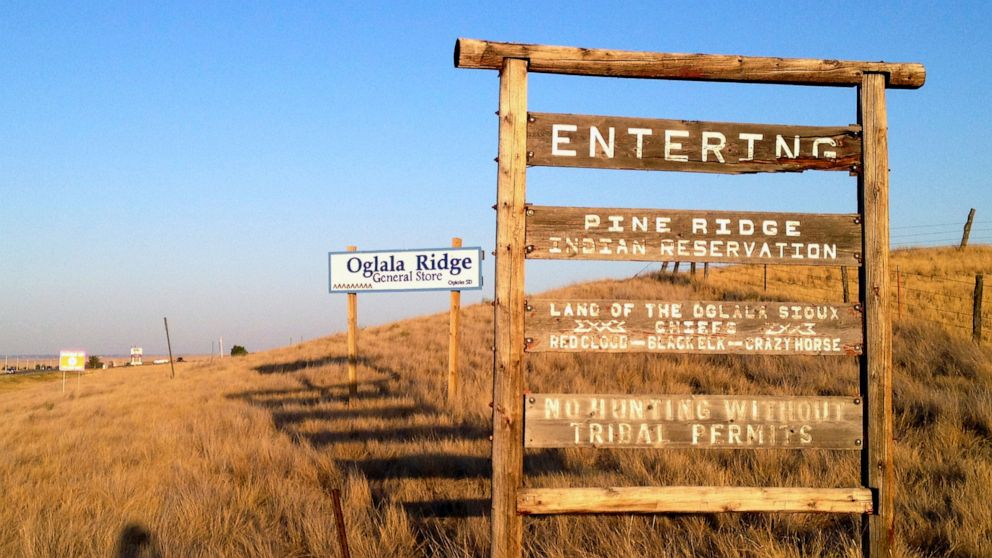 HOLD FOR USE WITH STORY MOVING THURSDAY, MARCH 19,2020-FILE - This Sept. 9, 2012 file photo shows the entrance to the Pine Ridge Indian Reservation in South Dakota, home to the Oglala Sioux tribe. Native American tribes across the U.S. for weeks have