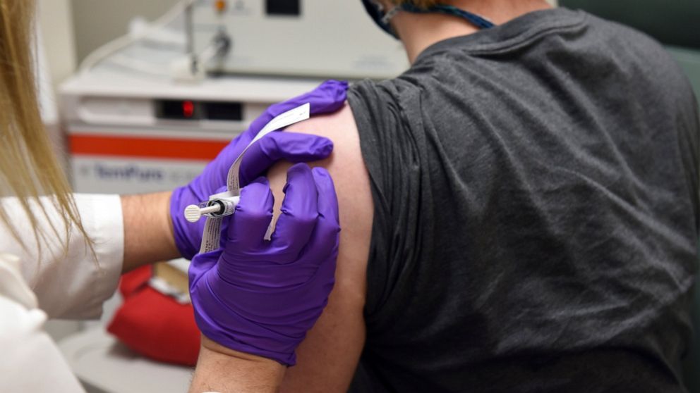 FILE - In this May 4, 2020 photo provided by the University of Maryland School of Medicine, the first patient enrolled in Pfizer's COVID-19 coronavirus vaccine clinical trial at the University of Maryland School of Medicine in Baltimore, receives an 