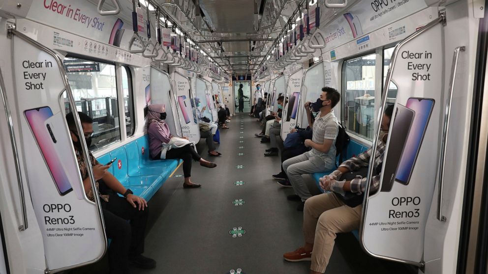 Passengers wearing face mask sit inside a MRT train in Jakarta, Indonesia, Monday, June 8, 2020. Indonesia’s capital of Jakarta, the city hardest hit by the new coronavirus, has partly reopened after two months of partial lockdown as the world’s four
