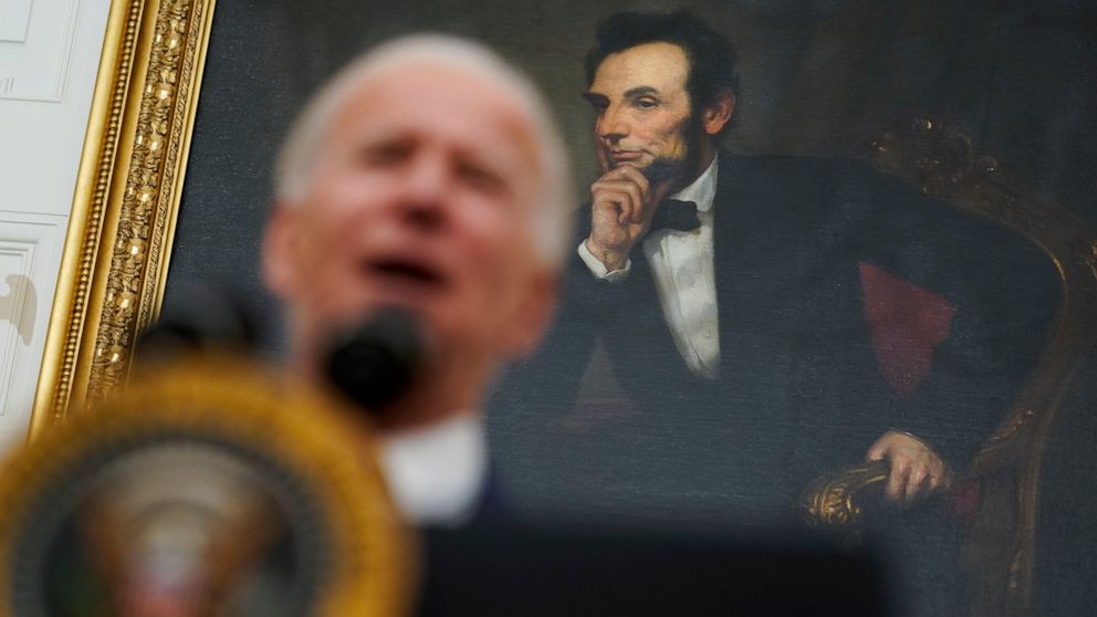 A portrait of former President Abraham Lincoln President hangs in the State Dining Room of the White House as Joe Biden delivers remarks on the economy Friday, Jan. 22, 2021, in Washington. (AP Photo/Evan Vucci)