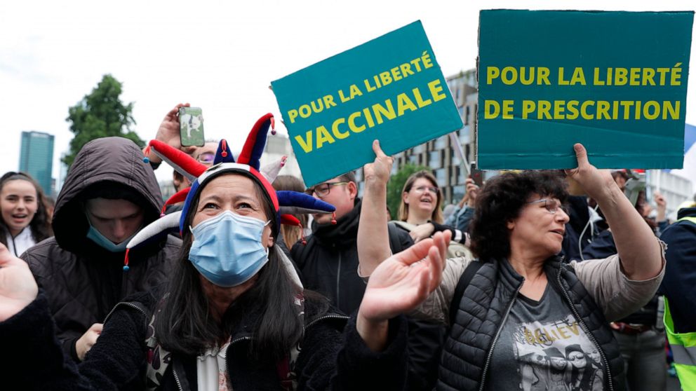 Anti-vax protesters against the vaccine and vaccine passports, during a demonstration in Paris, France, Saturday Aug. 7, 2021. Some thousands of people are expected to march in Paris and other French cities on Saturday to protest against a special vi