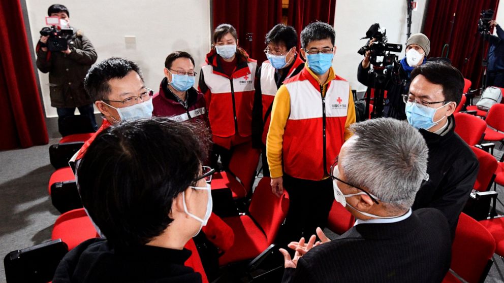 Chinese Ambassador to Italy, Li Junhua, 2nd right, talks to a team of Chinese medical experts prior to a news conference at the Red Cross headquarters in Rome, Friday, March 13, 2020. Italy has welcomed a team of Chinese medical experts and 31 tons o