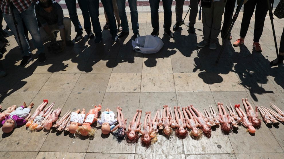 Dolls are laid out in front of Rabat's parliament by pro-choice protesters, to pressure legislatures to pass a law to protect women from unsafe and clandestine abortions, Morocco, Tuesday, June 25, 2019. The dolls symbolically exhibits the fate of un