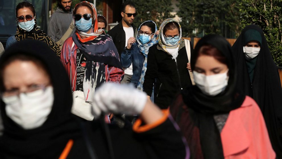 People wear protective face masks to help prevent the spread of the coronavirus in downtown Tehran, Iran, Sunday, Oct. 11, 2020. Iran announced on Sunday its highest single-day death toll from the coronavirus with 251 confirmed dead, the same day loc