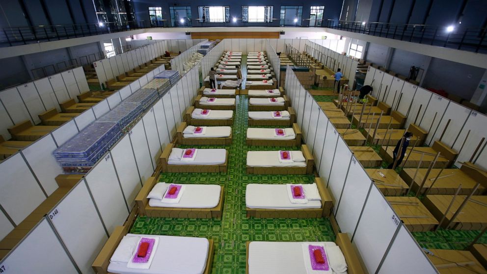 FILE - In this April 12, 2021, file photo, Thai workers prepare a field hospital for COVID-19 patients in Bangkok, Thailand. The country had seemed to be a virus success story and was just beginning to relax border quarantine requirements when a new 