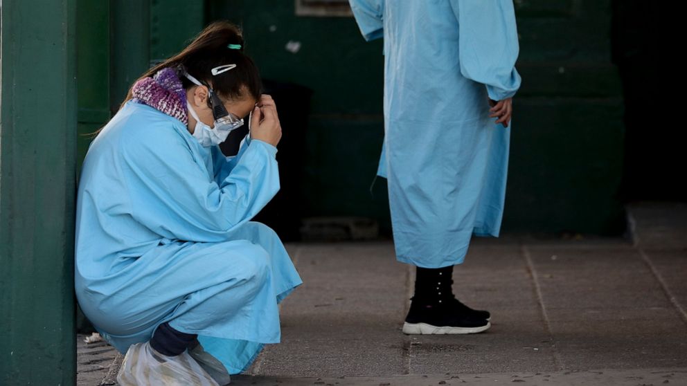A worker rests outside the Manuel Belgrano public hospital on the outskirts of Buenos Aires, Argentina, Friday, April 17, 2020. Argentina confirmed a coronavirus outbreak at this hospital where people, including hospital staff, have tested positive, 