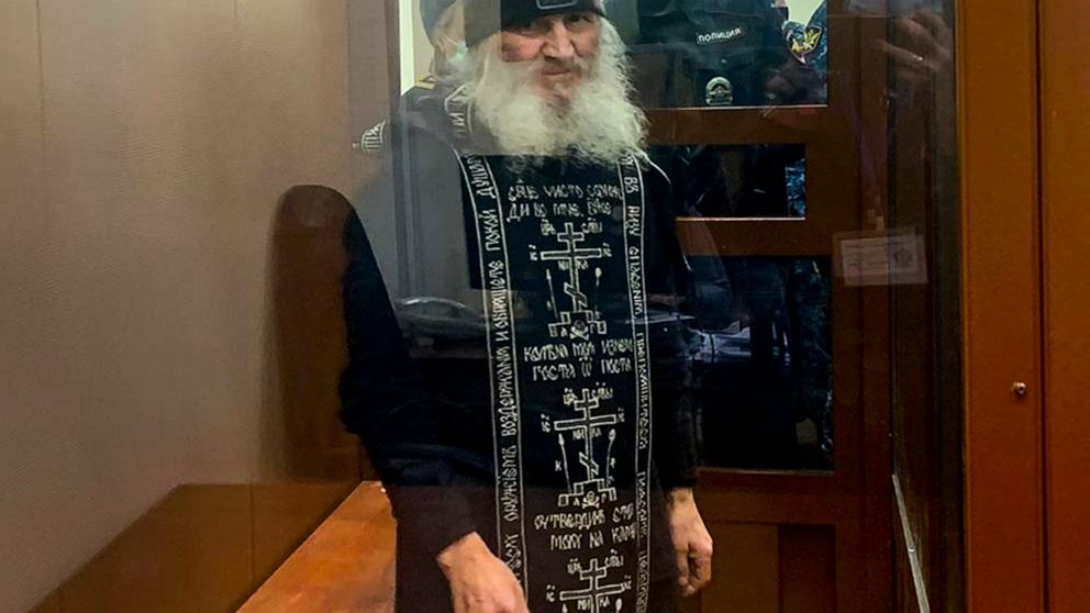 FILE - In this handout photo released by Basmanny Court via Moscow News Agency, Father Sergiy, a Russian monk who has defied the Russian Orthodox Church's leadership, stands in a cage prior to a court session in Moscow, Russia, Dec. 29, 2020. Father 