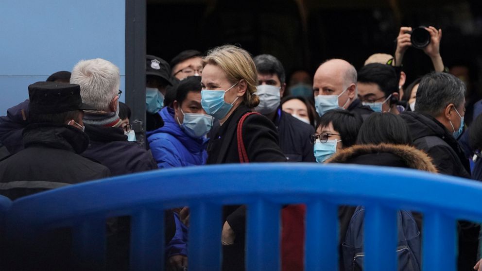 FILE - In this Jan. 31, 2021, file photo, the World Health Organization team is briefed outside of the Huanan Seafood Market on the third day of their field visit in Wuhan, China. Chinese officials briefed diplomats Friday, Masrch 26, 2021, on the on