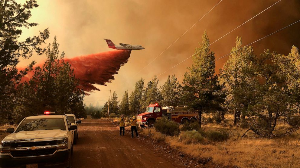FILE - This photo provided by the Oregon Department of Forestry shows a firefighting tanker making a retardant drop over the Grandview Fire near Sisters, Ore., Sunday, July 11, 2021. The wildfire doubled in size to 6.2 square miles (16 square kilomet