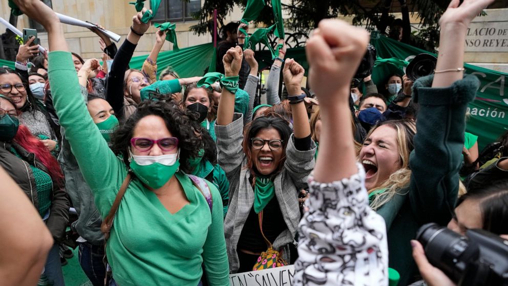 Abortion-rights activists celebrate after the Constitutional Court approved the decriminalization of abortion, lifting all limitations on the procedure until the 24th week of pregnancy, in Bogota, Colombia, Monday, Feb. 21, 2022. (AP Photo/Fernando V