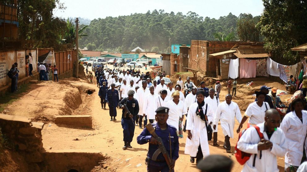 Doctors and health workers march in the Eastern Congo town of Butembo on Wednesday April 24, 2019, after attackers last week shot and killed an epidemiologist from Cameroon who was working for the World Health Organization. Doctors at the epicenter o
