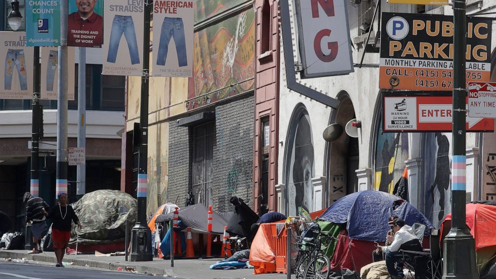 FILE - In this April 18, 2020, file photo, tents line a sidewalk on Golden Gate Avenue in San Francisco. A coalition in California is proposing legislation to boost taxes on wealthy multi-national corporations to raise more than $2 billion a year to 