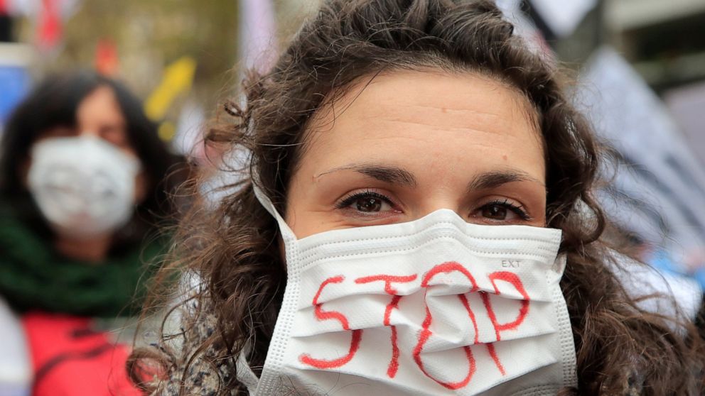A medical staff wears a mask during a national demonstration Thursday, Nov. 14, 2019 in Paris. Among the demands being made are more staff , pay rises, in particular for those on low salaries, and providing more beds. (AP Photo/Michel Euler)