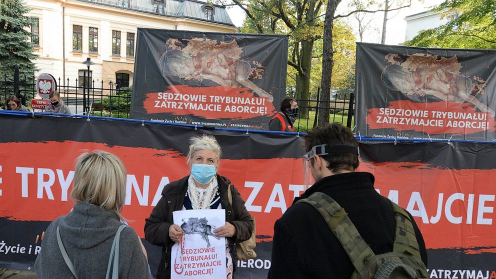 Anti-abortion activists attend a protest in front of Poland's constitutional court, in Warsaw, Poland, Thursday, Oct. 22, 2020. Poland’s top court has ruled that a law allowing abortion of fetuses with congenital defects is unconstitutional. The deci