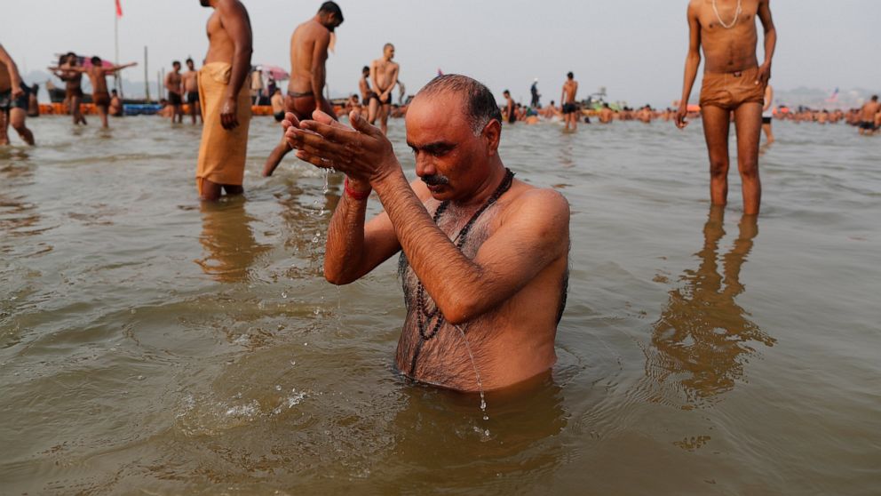 Hindu devotees take ritualistic dips in the Sangam, the confluence of three rivers — the Ganges, the Yamuna and the mythical Saraswati, during Makar Sankranti festival that falls during the annual traditional fair of Magh Mela festival, one of the mo