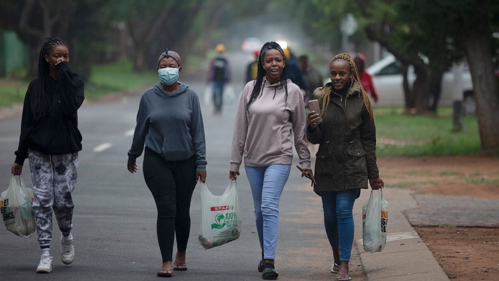 Students from the Tshwane University of Technology make their way back to their residence in Pretoria, South Africa, Saturday, Nov. 27, 2021. As the world grapples with the emergence of the new variant of COVID-19, scientists in South Africa — where 