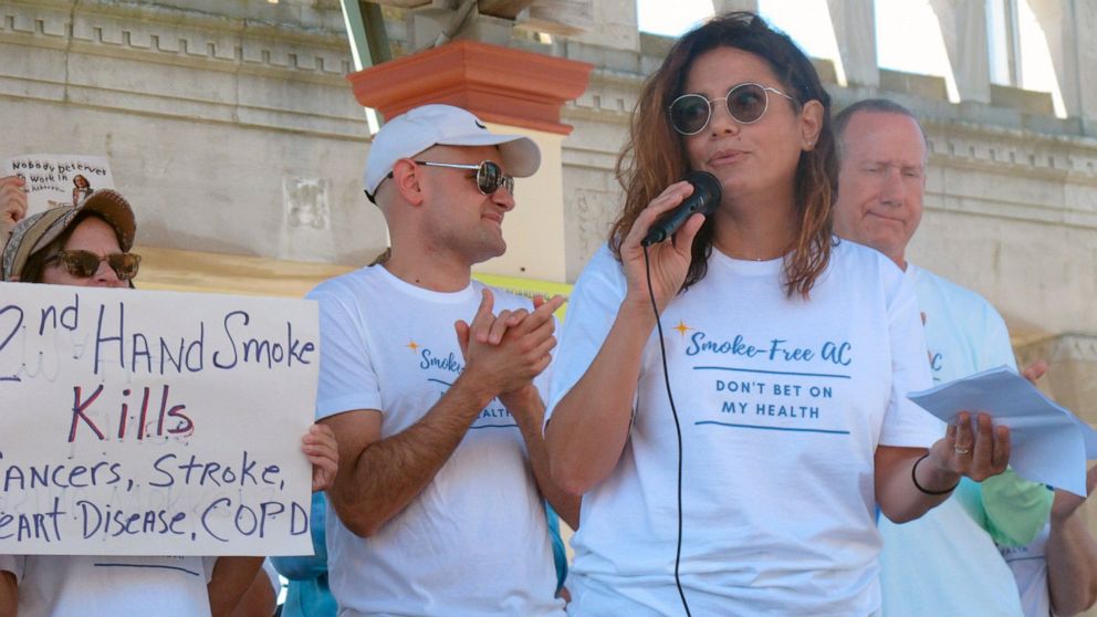 Casino dealer Nicole Vitola speaks at a rally Wednesday, June 30, 2021 on the Atlantic City N.J., Boardwalk calling for a permanent ban on smoking in Atlantic City's nine casinos. The coronavirus-inspired temporary ban will expire on Sunday July 4. (