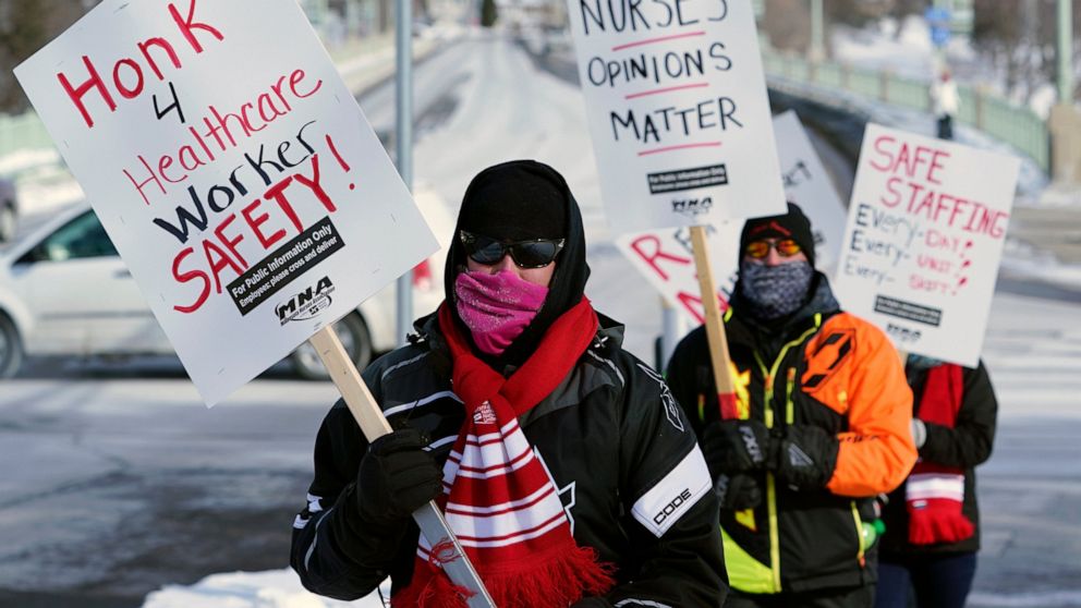 Nurses picket Friday, Feb. 12, 2021 in Faribault, Minn., during a healthcare worker protest of a shortage on protective masks. One year into the COVID-19 pandemic, the U.S.  finds itself with many millions of N95 masks pouring out of American factori