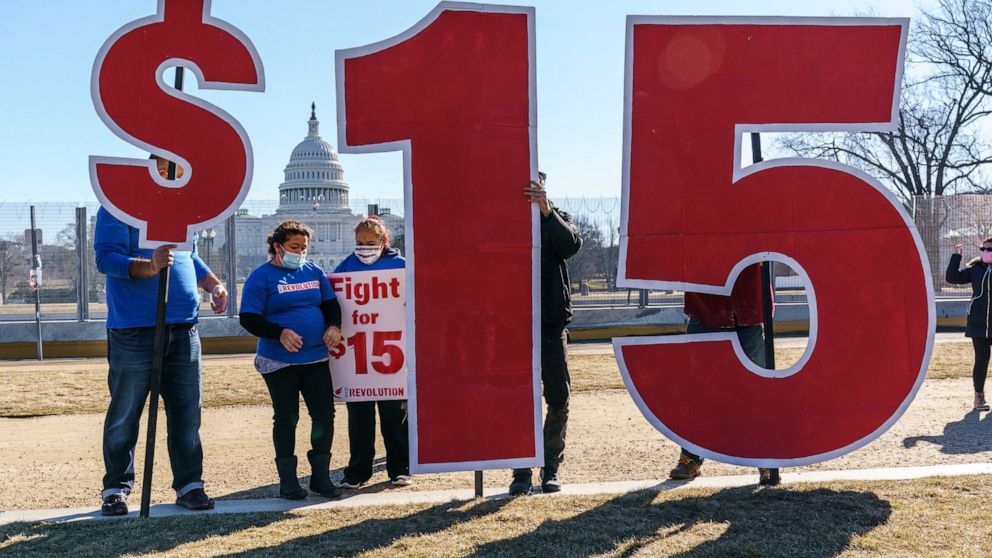 Activists appeal for a $15 minimum wage near the Capitol in Washington, Thursday, Feb. 25, 2021. The $1.9 trillion COVID-19 relief bill being prepped in Congress includes a provision that over five years would hike the federal minimum wage to $15 an 