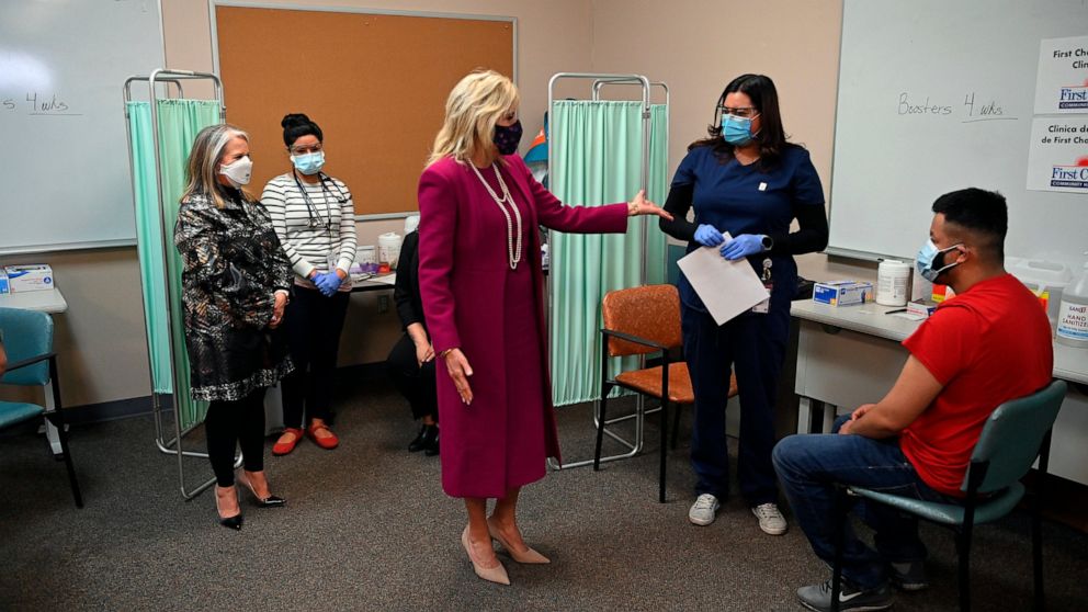 First lady Jill Biden and New Mexico Gov. Michelle Lujan Grisham, left, visit a COVID-19 vaccination center at First Choice Community Healthcare - South Valley Medical Center in Albuquerque, N.M., Tuesday, April 21, 2021. (Mandel Ngan/Pool via AP)