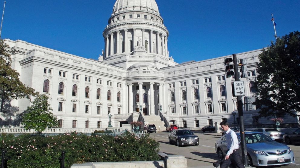 FILE - This Oct. 10, 2012, file photo shows a man walking by the Wisconsin state Capitol in Madison. The Wisconsin Supreme Court’s conservative majority ruled on Thursday, July 7, 2022, that a transgender woman cannot change her name because she is o