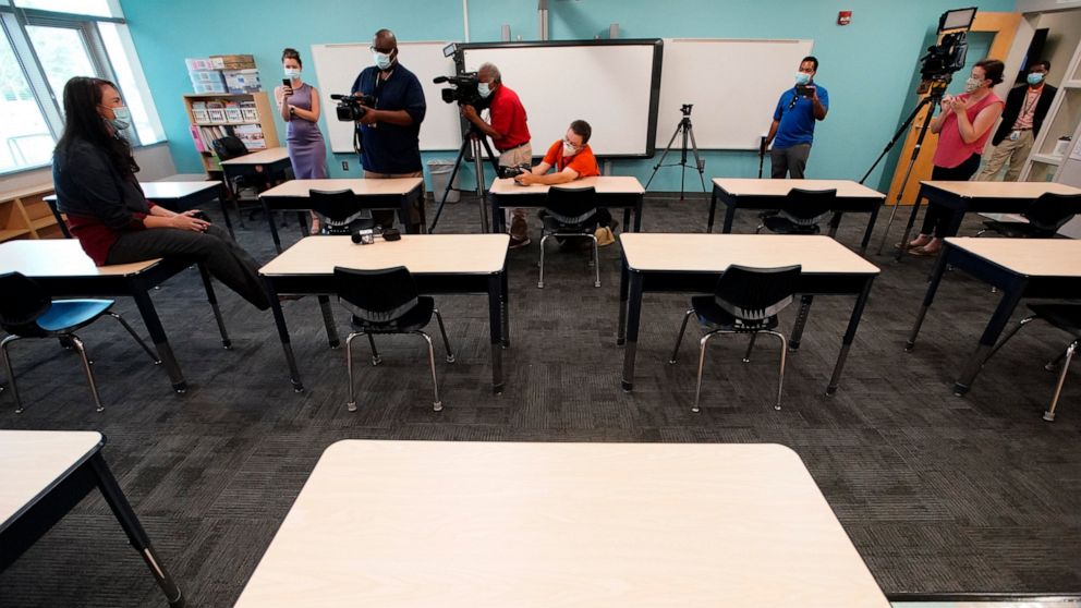Principal Susan Stevens talks to the media during a demonstration of a socially-distanced classroom at A.J. Whittenberg Elementary School of Engineering Monday, July 20, 2020, in Greenville, S.C. (AP Photo/Chris Carlson)