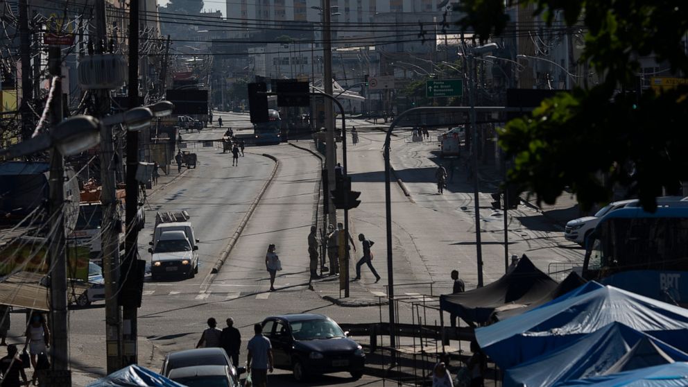 An avenue is partially empty amid increased restrictions on movements in an effort to curb the spread of the new coronavirus in the Madureira neighborhood of Rio de Janeiro, Brazil, Tuesday, May 12, 2020. (AP Photo/Silvia Izquierdo)
