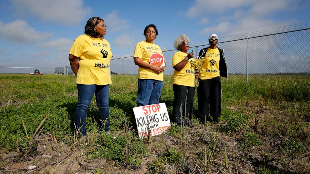 FILE - Myrtle Felton, from left, Sharon Lavigne, Gail LeBoeuf and Rita Cooper, members of RISE St. James, conduct a live stream video on property owned by Formosa on March 11, 2020, in St. James Parish, La. A Louisiana judge has thrown out air qualit
