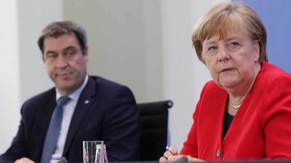 FILE - In this Wednesday, May 6, 2020 file photo Bavarian Governor Markus Soeder and German Chancellor Angela Merkel address the media during a joint press conference in Berlin, Germany. Armin Laschet, a governor who also leads Merkel’s party, called