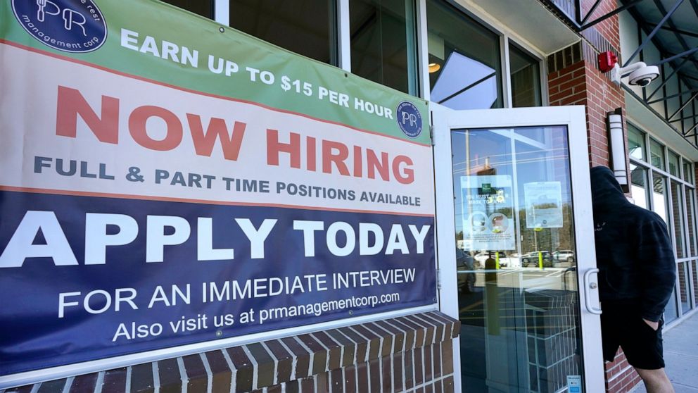 A man walks into a restaurant displaying a "Now Hiring" sign, Thursday, March 4, 2021, in Salem, N.H. U.S. employers added a robust 379,000 jobs last month, the most since October and a sign that the economy is strengthening as confirmed viral cases 