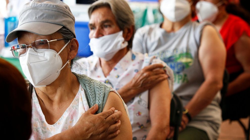 FILE - Persons over 60-years-old wait in observation after receiving their second dose of the AstraZeneca COVID-19 vaccine at the University Olympic Stadium in Mexico City, April 12, 2021. Mexican officials announced Tuesday, Nov. 30, 2021, that they
