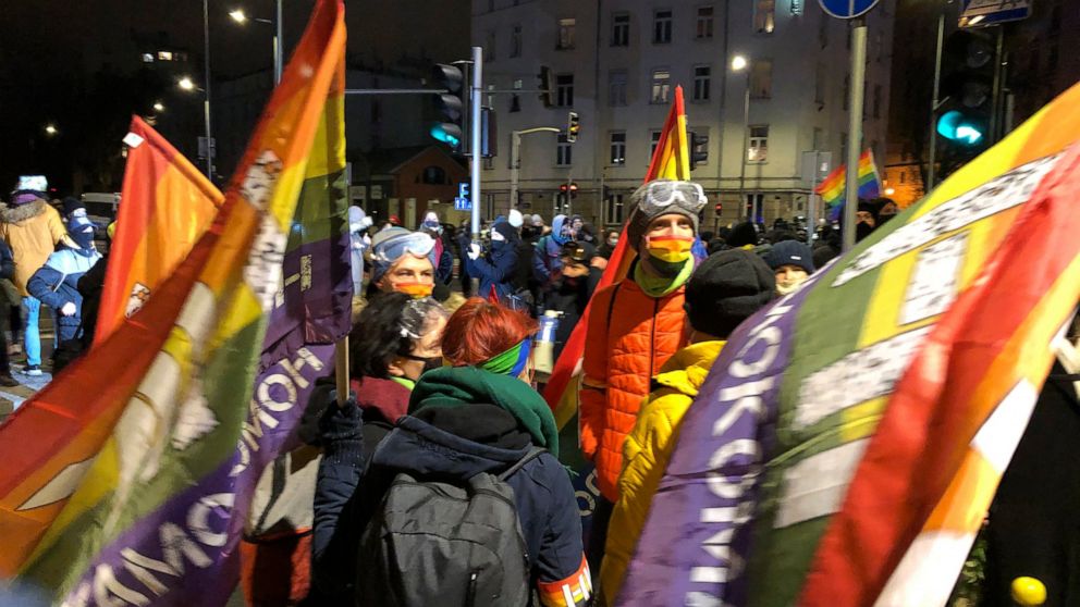 People gather in Warsaw, Poland Wednesday Jan. 27, 2021 to protest after the country's top court on Wednesday confirmed its highly divisive ruling that will further tighten the predominantly Catholic nation's strict anti-abortion law. The Constitutio