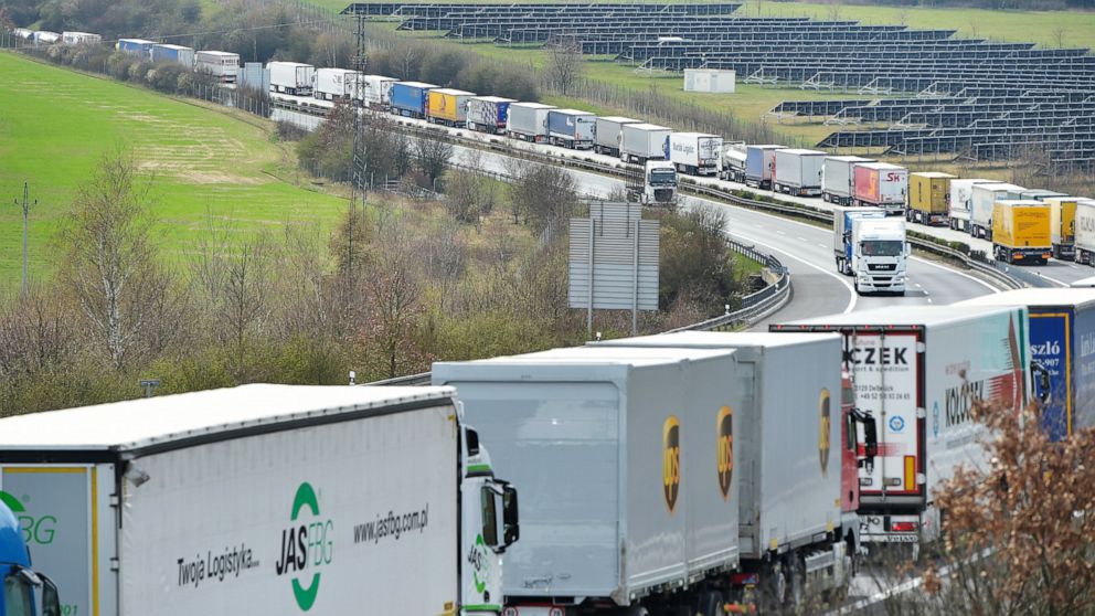 Trucks are jammed on the motorway D5 in front of the Czech-German border crossing in Rozvadov, Czech Republic, Wednesday, April 15, 2020. The trucks are piling up for a length of 15 kilometres due to border controls as part of efforts to curb the spr