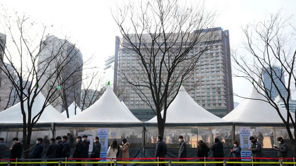 People wait for a coronavirus test at a makeshift testing site in Seoul, South Korea, Friday, March 4, 2022. (AP Photo/Ahn Young-joon)