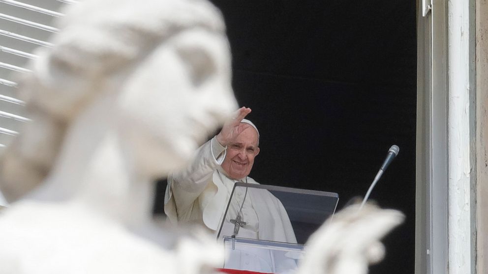 Pope Francis delivers his blessing as he recites the Regina Caeli noon prayer from the window of his studio overlooking St.Peter's Square, at the Vatican, Sunday, April 18, 2021. Pope Francis said he is happy to be back greeting the faithful in St. P