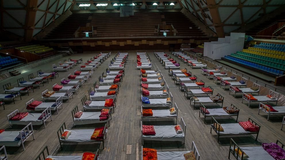 Beds lie inside an indoor stadium converted into COVID-19 treatment center for emergencies in the wake of the spike in the numbers of positive coronavirus cases in Srinagar, Indian controlled Kashmir, Wednesday, April 28, 2021. India, a country of ne