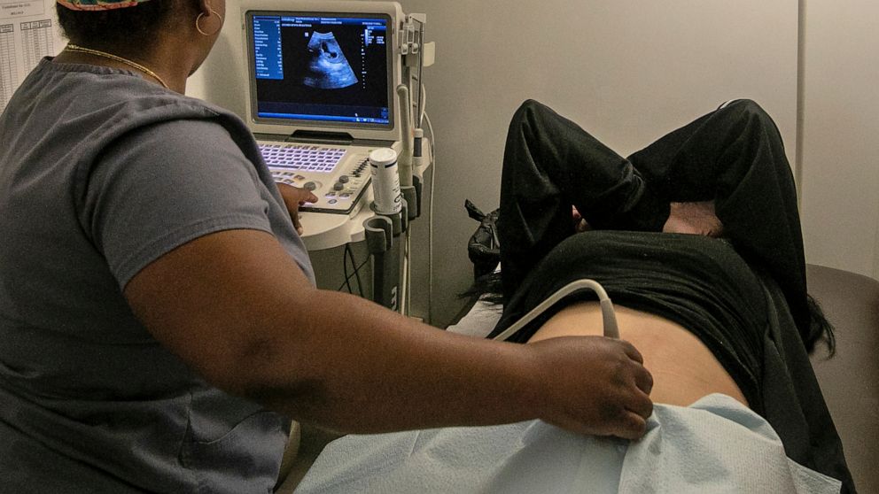 FILE - An operating room technician performs an ultrasound on a patient at an abortion clinic in Shreveport, La., Wednesday, July 6, 2022. Serious pregnancy complications are rare in the United States but they still affect thousands of women each yea