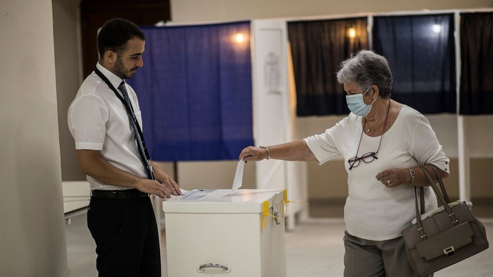 A woman casts her vote at a polling station during a referendum in Gibraltar, Thursday, June, 24, 2021. Gibraltar is holding a referendum on whether to introduce exceptions to the British territory's ban on abortion. Abortion is illegal in Gibraltar,
