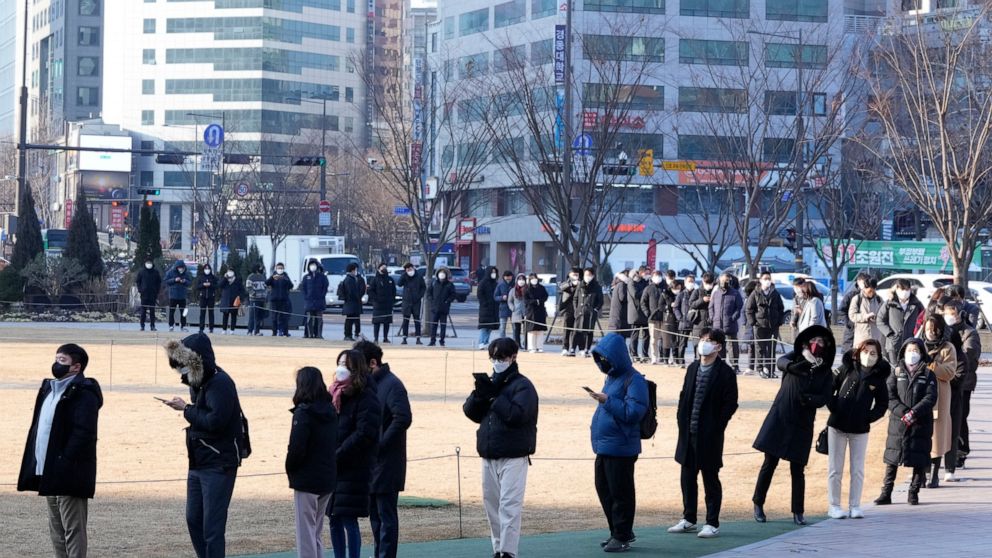 People wait for their coronavirus test at a makeshift testing site in Seoul, South Korea, Wednesday, Feb. 16, 2022. (AP Photo/Ahn Young-joon)