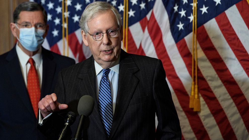 FILE - In this Tuesday, Dec. 15, 2020, file photo, Senate Majority Leader Mitch McConnell, of Kentucky, speaks during a news conference with other Senate Republicans on Capitol Hill in Washington, while Sen. John Barrasso, R-Wyoming, listens at left.