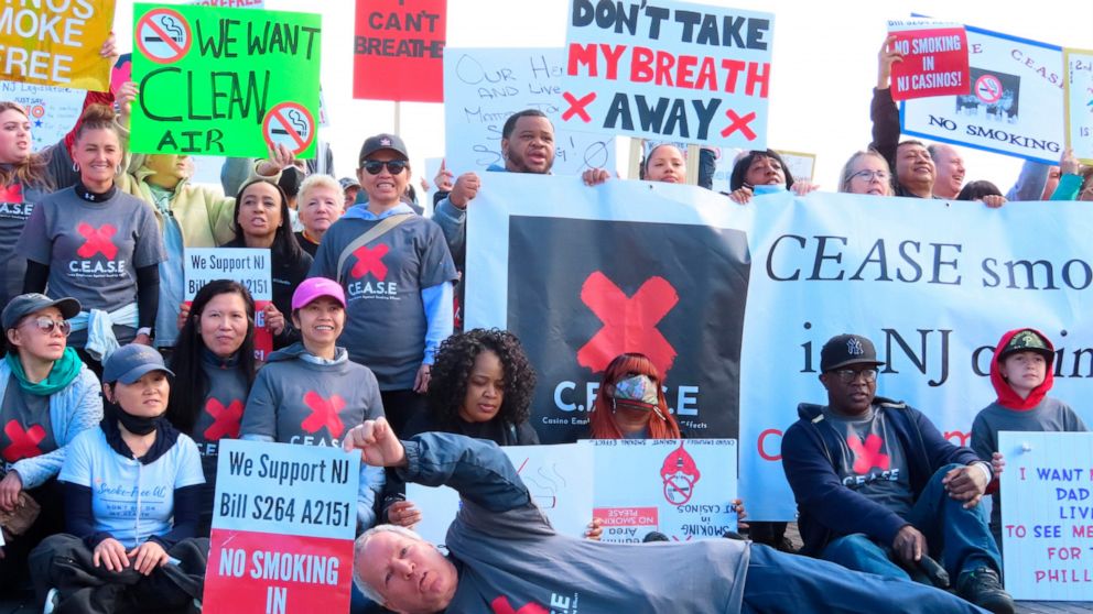 Casino workers hold a rally in Atlantic City, N.J., Tuesday, April 12, 2022, to call on the state Legislature to pass a bill to ban smoking inside the nine casinos. The rally was held on the 16th anniversary of a New Jersey that banned indoor smoking