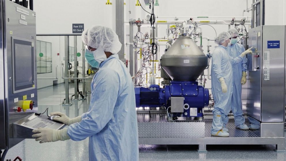 In this undated image from video provided by Regeneron Pharmaceuticals on Friday, Oct. 2, 2020, scientists work with a bioreactor at a company facility in New York state, for efforts on an experimental coronavirus antibody drug. Antibodies are protei