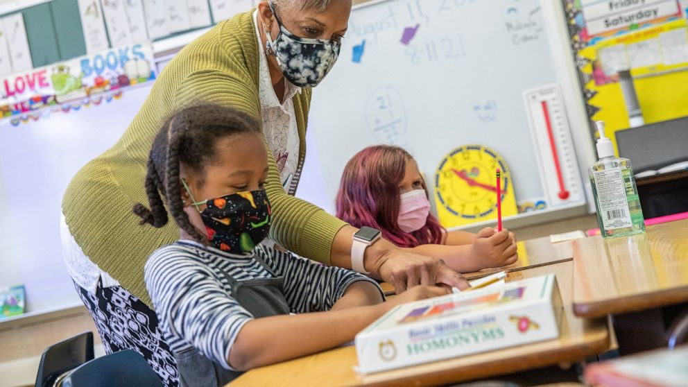 FILE — In this Aug. 11, 2021, file photo Joy Harrison instructs her second graders at Carl B. Munck Elementary School, in Oakland, Calif. Public school teachers and staff returning to the classroom in August fueled another impressive month of job gai
