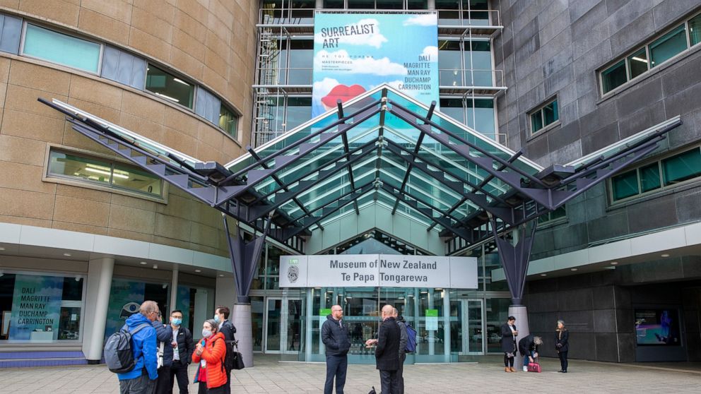 Visitors stand outside Te Papa museum in Wellington, New Zealand, Wednesday, June, 23, 2021. After enjoying nearly four months without any community transmission of the coronavirus, New Zealanders were on edge Wednesday after health authorities said 